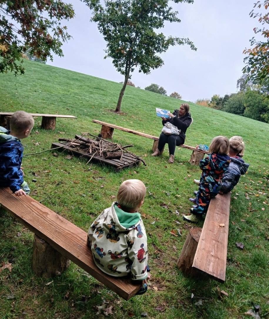 Children enjoying a woodland story session at Lilleshall Preschool
